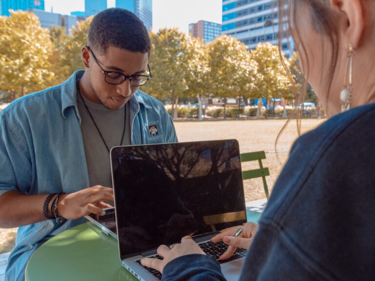 Two students looking at electronic devices