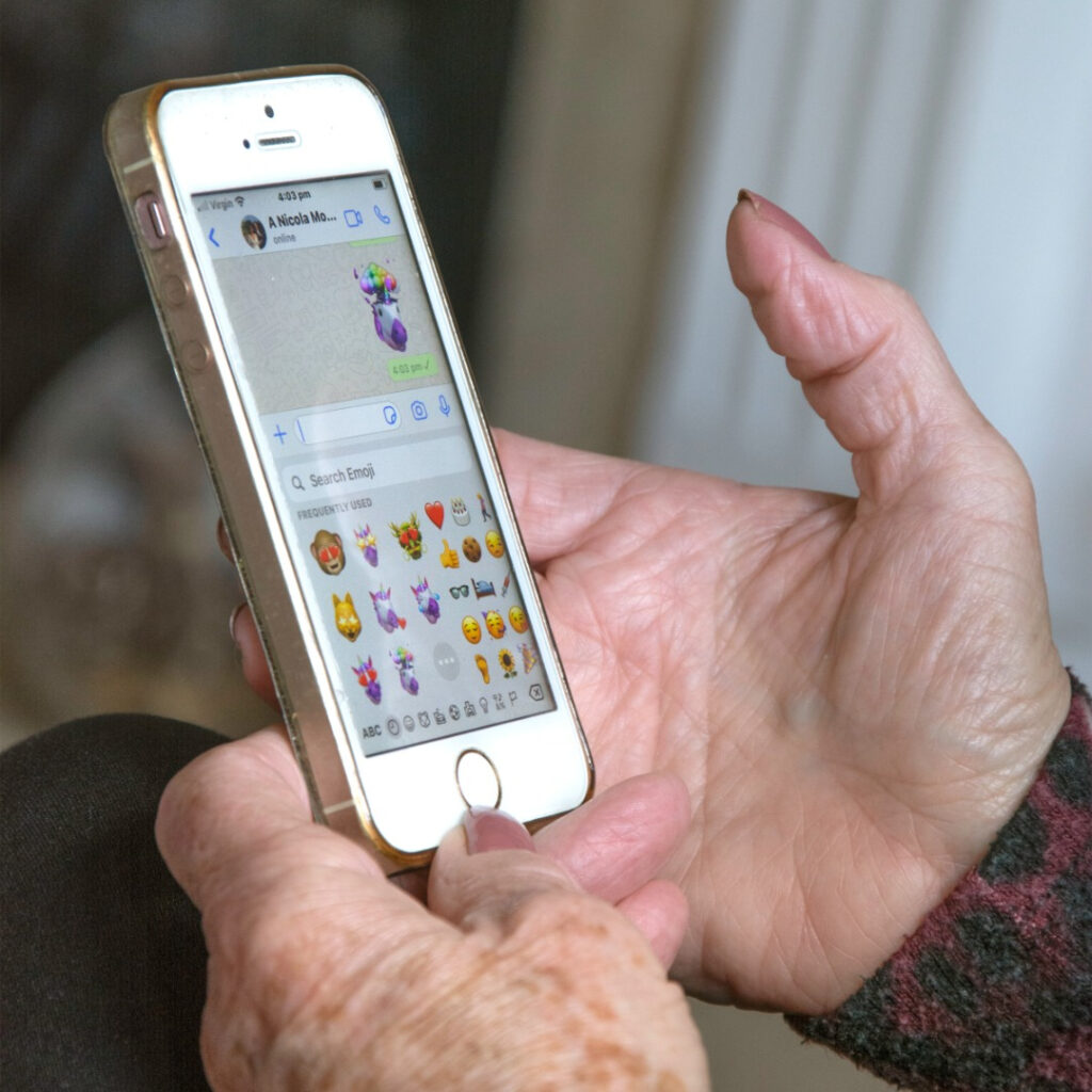 an older lady uses a smartphone 