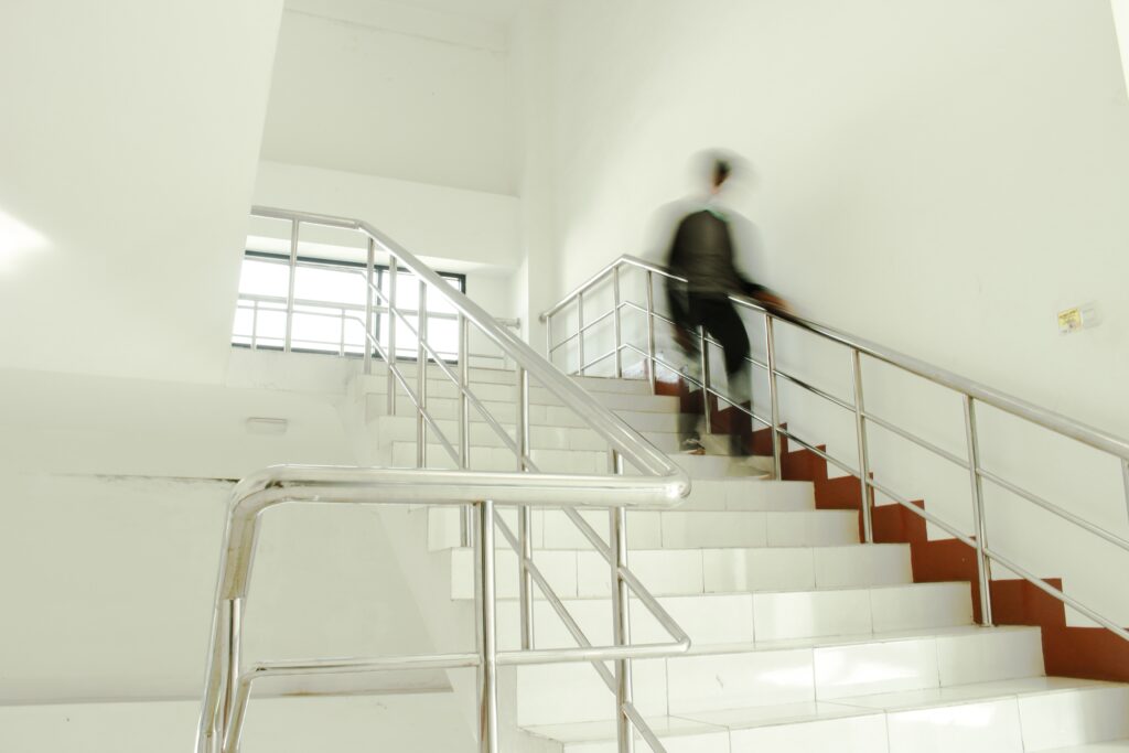 A boy walks down a staircase 