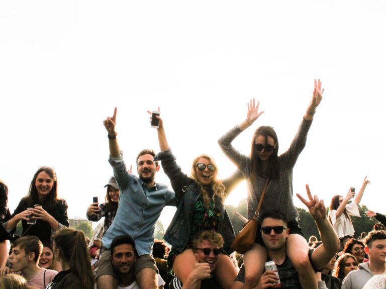 Some people sit on shoulders at a gathering