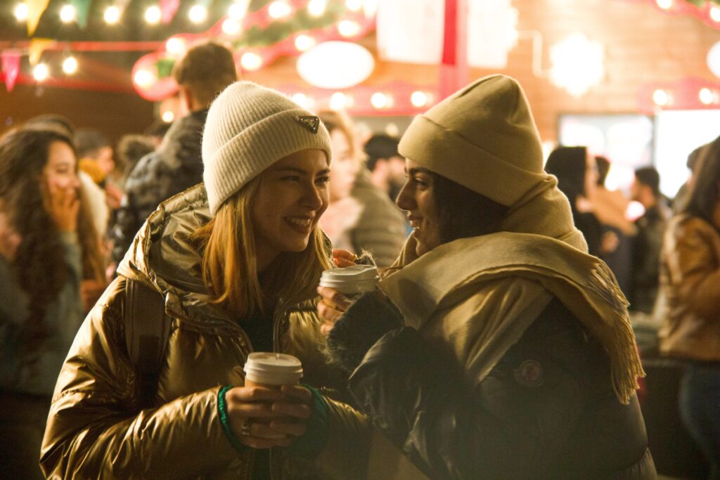two students attend a Christmas market 