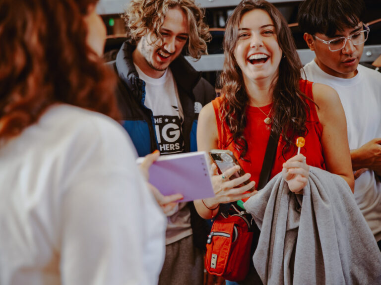 A girl laughs at a Freshers Fair